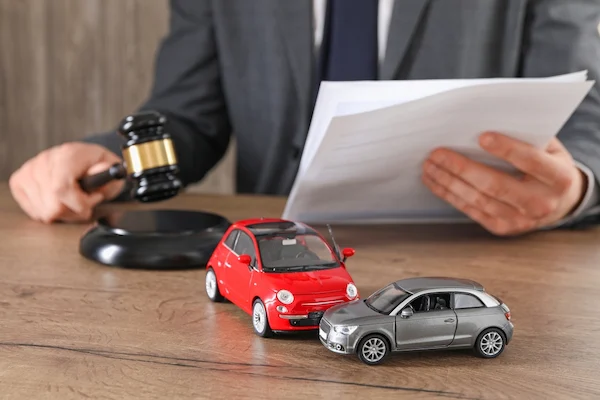 A Tampa car accident lawyer works on a case at a desk with toy cars.