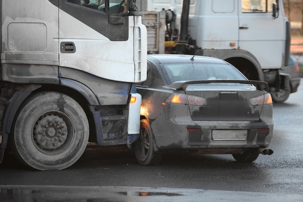 A commercial truck hits a car.